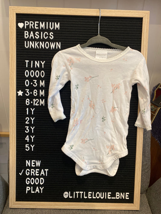 White longsleeved onesie with floral pattern