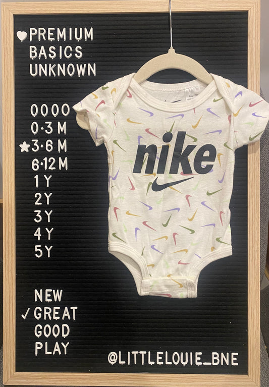Nike white onesie with pastel ticks